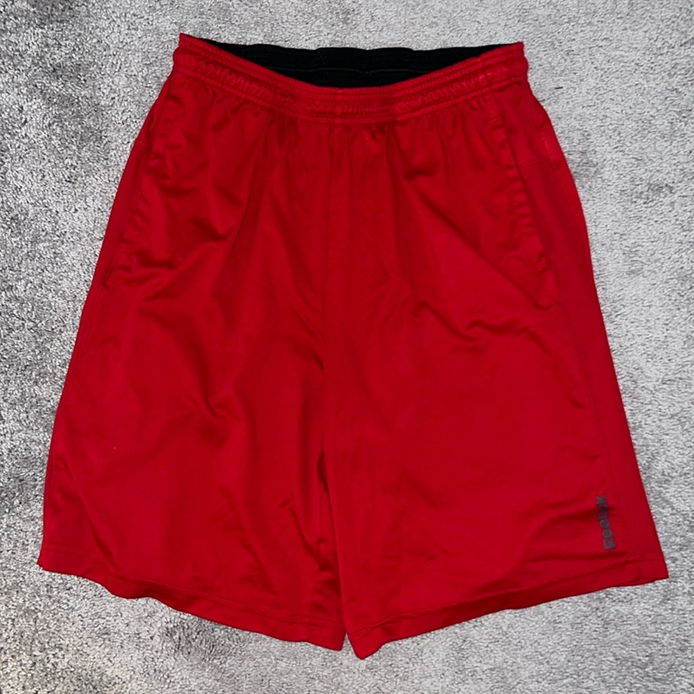 Red Reebok athletic shorts. Size M